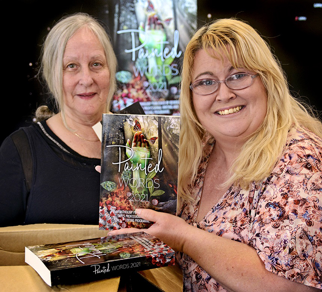 two ladies holding the book