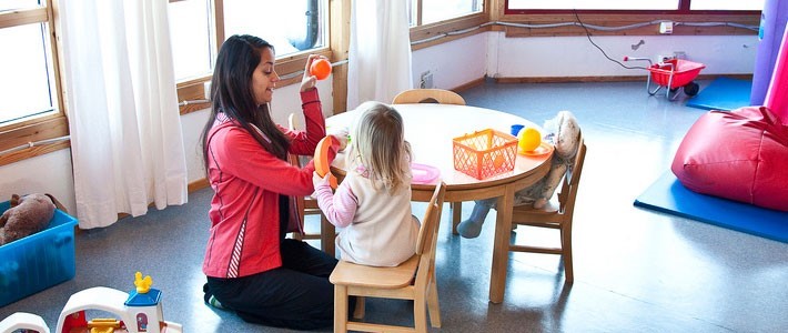 Female educator playing with young child