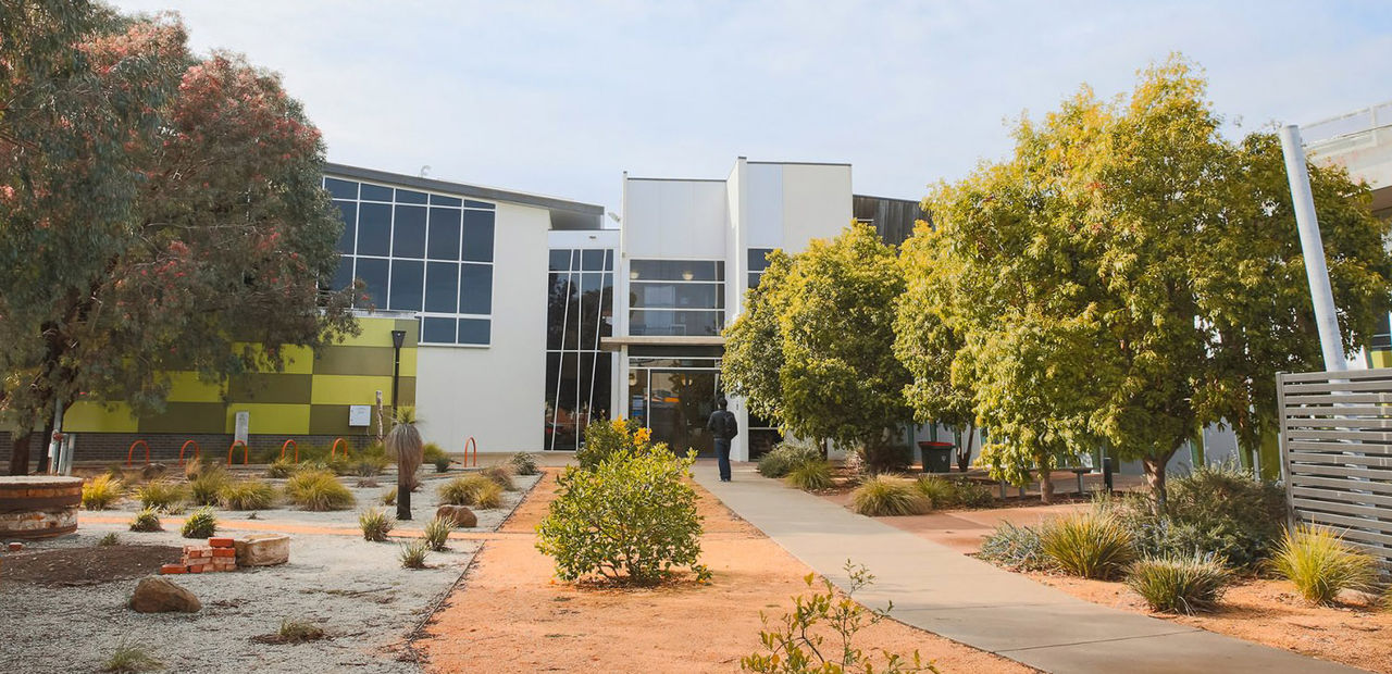 Entrance to Bendigo TAFE's Echuca campus, showing a garden with trees and plants