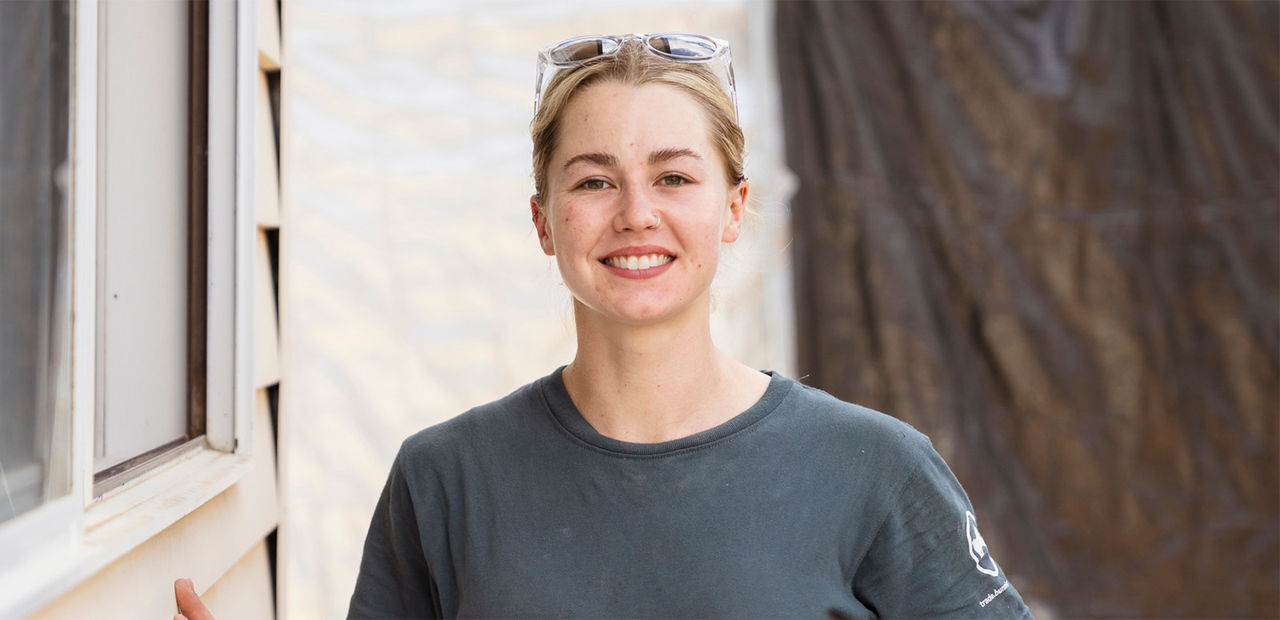 Photo of a young female carpentry apprentice, smiling